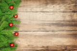 Christmas wooden background with Christmas tree branches and Christmas ornaments