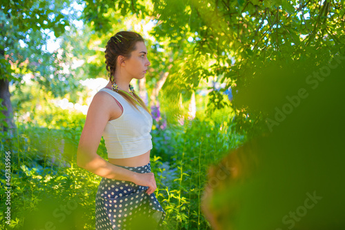 Woman model poses for a photographer in nature
