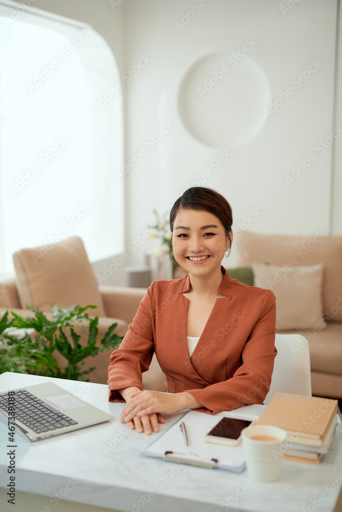 Asian woman working in home office with laptop. Asian woman working in home office with laptop.
