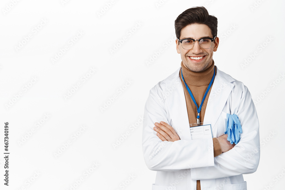 Smiling professional doctor, male physician cross arms on chest and looking confident, white background
