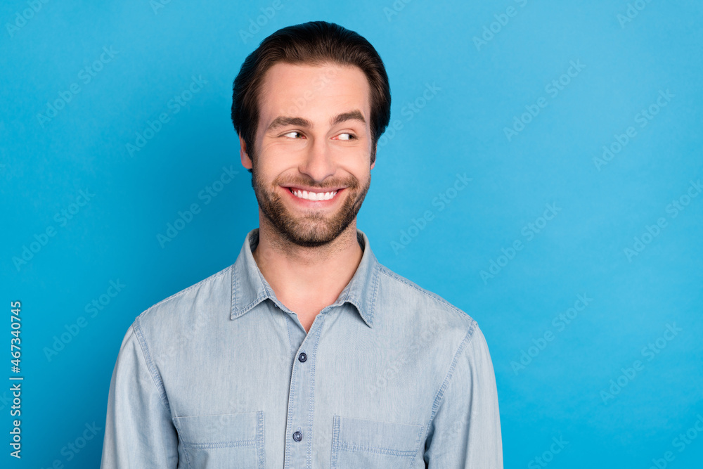 Portrait of attractive cheerful man director looking aside copy space isolated over vibrant blue color background Portrait of attractive cheerful man director looking aside copy space isolated over vibrant blue color background