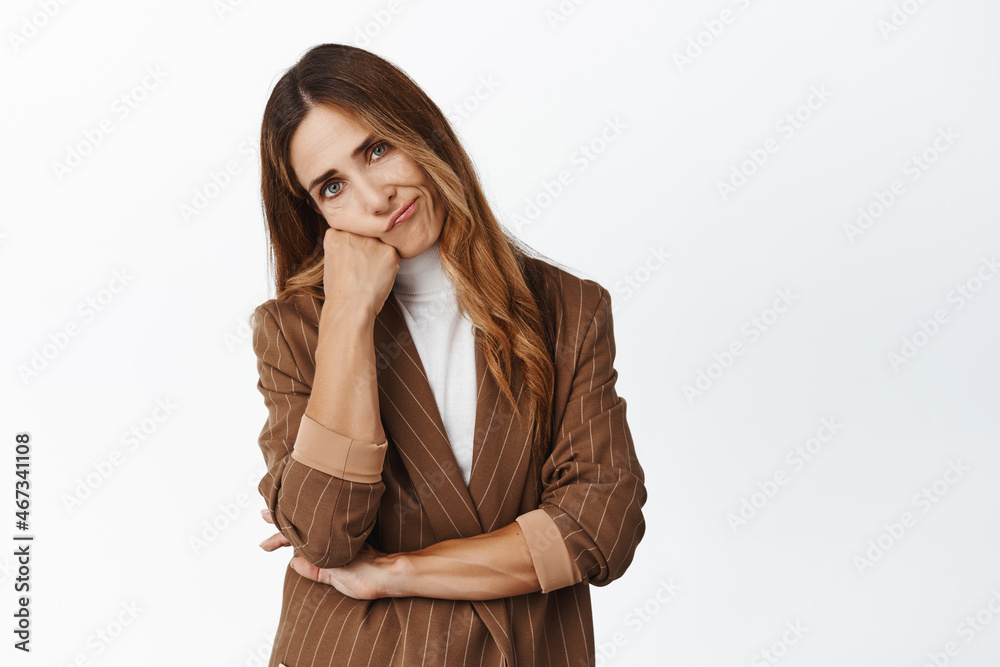 Portrait of corporate woman facing failure, difficulties at work, looking with upset and disappointed face, lean head on hand, standing reluctant against white background Portrait of corporate woman facing failure, difficulties at work, looking with upset and disappointed face, lean head on hand, standing reluctant against white background