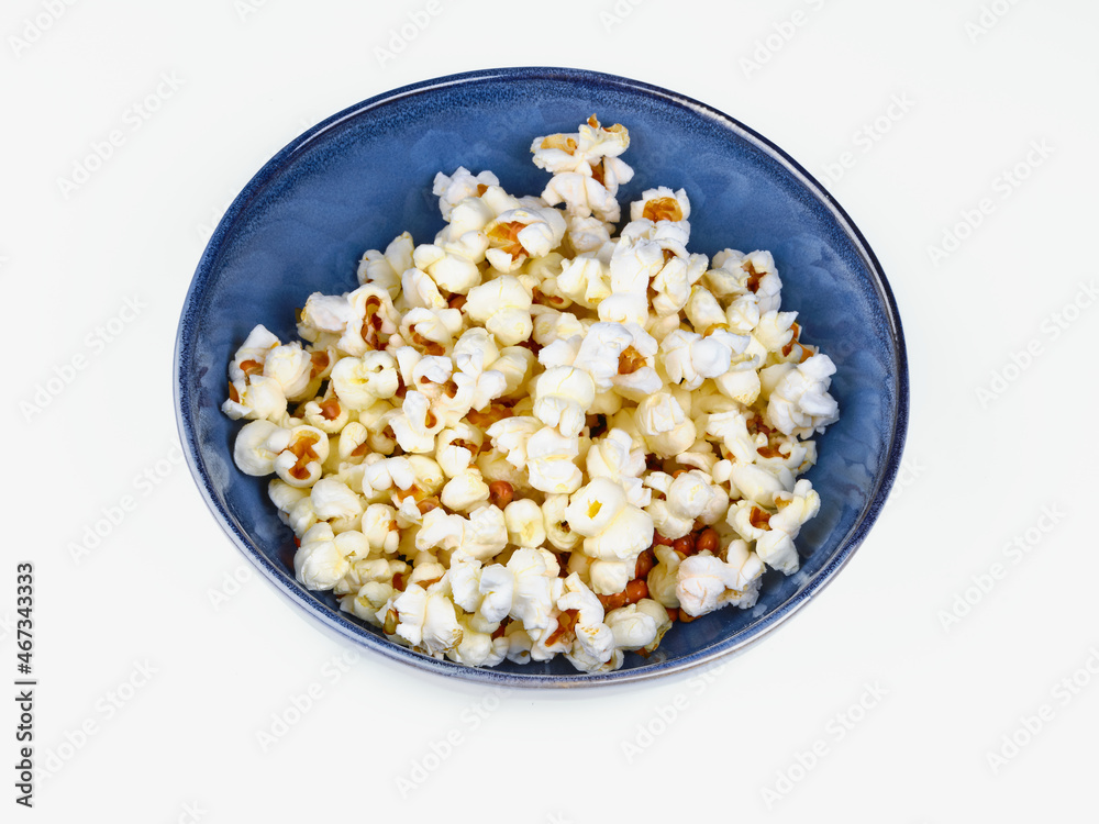 popcorn on blue bowl isolated on white background popcorn on blue bowl isolated on white background