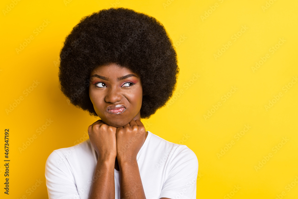 Photo of unhappy sad dark skin young woman look empty space bad mood isolated on yellow color background Photo of unhappy sad dark skin young woman look empty space bad mood isolated on yellow color background