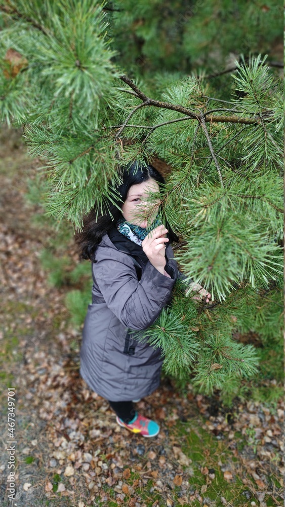 Naklejka premium Young woman resting in a pine forest