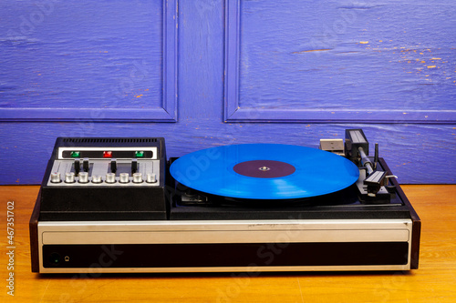 Vintage turntable vinyl record player with blue vinyl