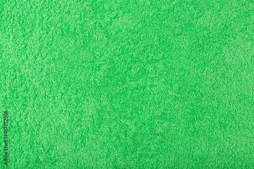 Green fluffy towel fabric close up. Abstract background with space for text. Template concept