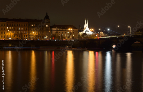 Night city landscape with river, street lights are reflected in the water surface