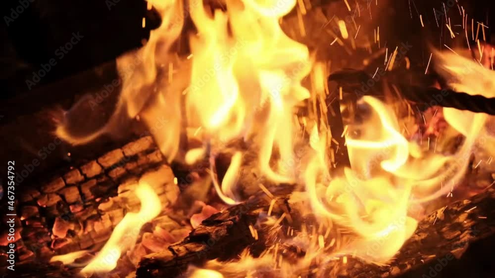 Beautiful bonfire in the night. Hot fiery coals are raked with a poker Beautiful bonfire in the night. Hot fiery coals are raked with a poker