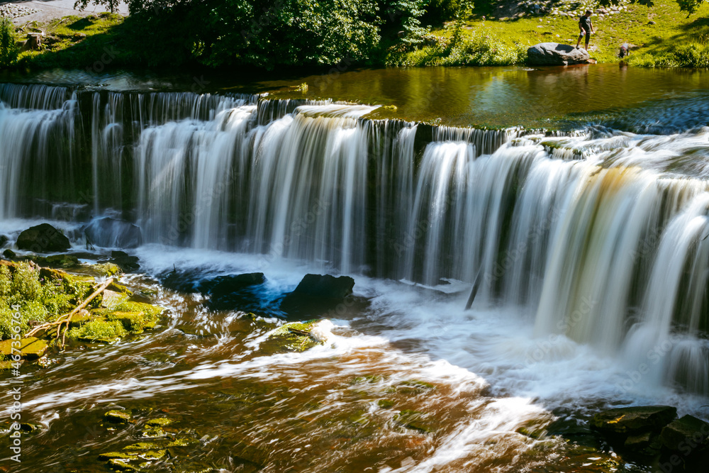 Obraz premium Keila waterfall located on Keila River in Harju County near Tallinn, Estonia. Water flowing in the middle of the forest