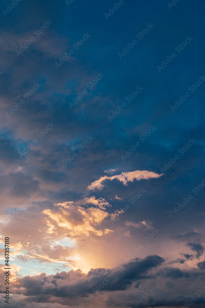 A cloud illuminated by a sun in the evening sky at sunset