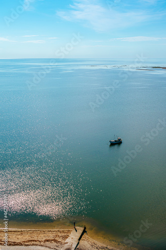 Small fishing boat in the sea. Clear blue sky and water. Baltic sea. Coast of the Sorve peninsula in Saaremaa, Estonia