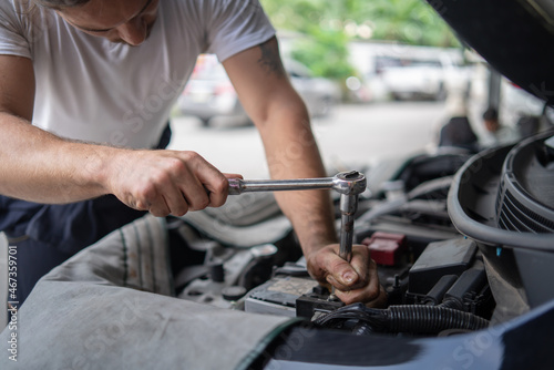 Mechanic changing engine, service car workshop automobile. professional man shop maintenance