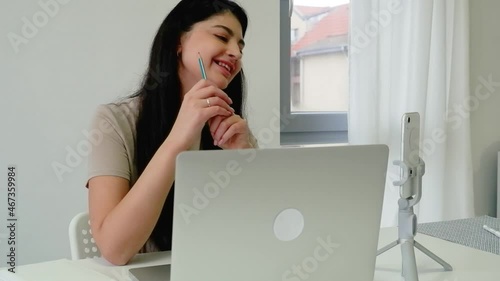 Young woman communicates by video call. Ethnic businesswoman talking looking at laptop computer, online conference remote office chat, virtual learning concept.