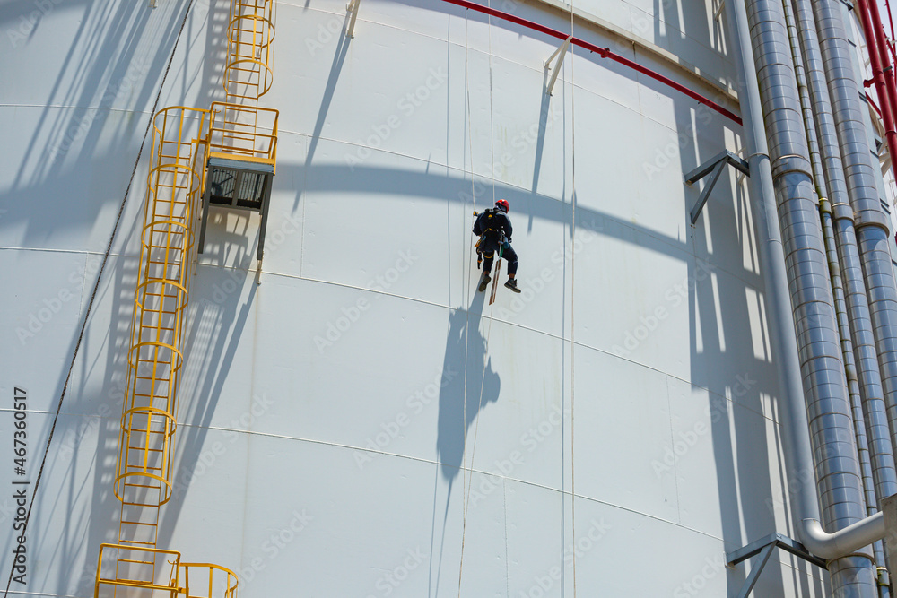 Male worker down height tank shell plate rope ladder access safety inspection of thickness storage tank gas Male worker down height tank shell plate rope ladder access safety inspection of thickness storage tank gas