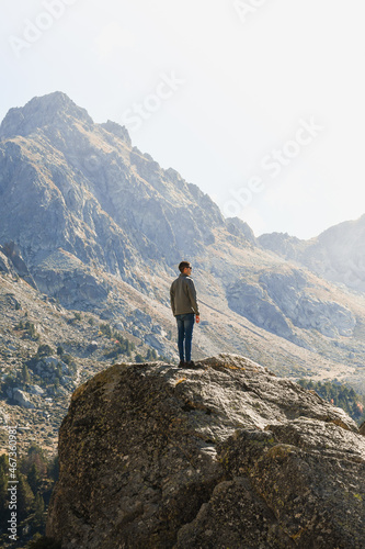 Young hiker on top of a rock enjoying mountain views in Andorra