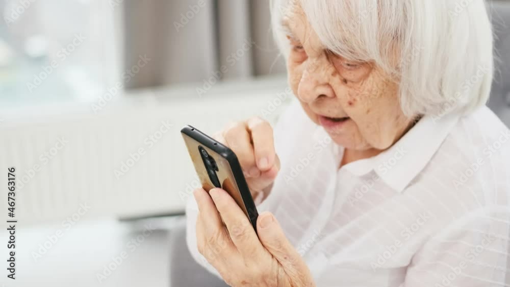 Closeup view how elderly woman talking by video call using smartphone Closeup view how elderly woman talking by video call using smartphone