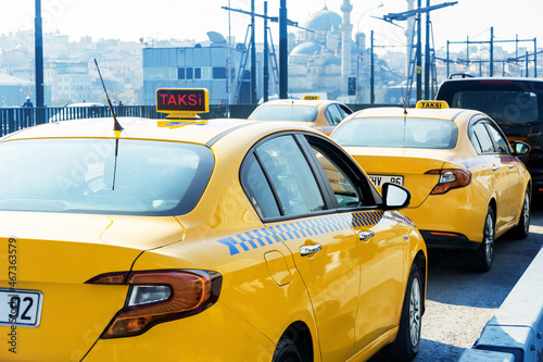 View of a traditional yellow Turkish taxi in the streets of istanbul city. Trancport city concept.