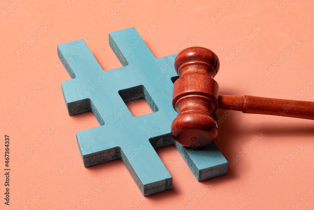hashtag and justice hammer symbolizing cyber crimes