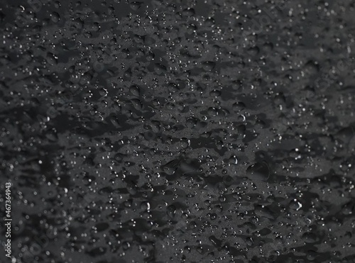 Bilde på lerret Black wet background with water drops, textured glass surface and bubble pattern, and creative bokeh effect
