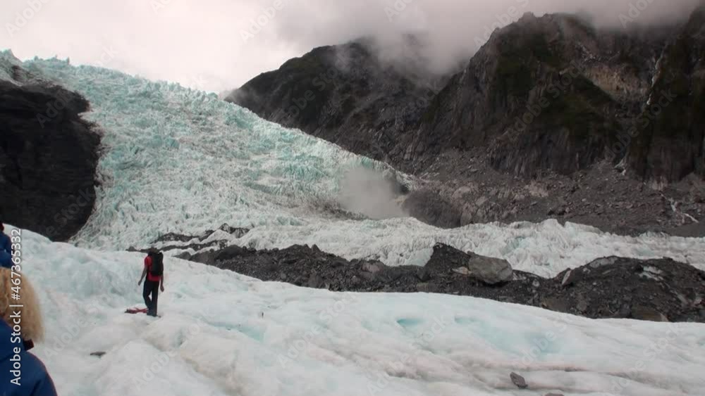 New Zealand, 12 October 2013: People tourists in snowy mountains.Scenic peaks and ridges. Beautiful background of amazing nature. Travel and tourism in the world of wildlife. New Zealand, 12 October 2013: People tourists in snowy mountains.Scenic peaks and ridges. Beautiful background of amazing nature. Travel and tourism in the world of wildlife.