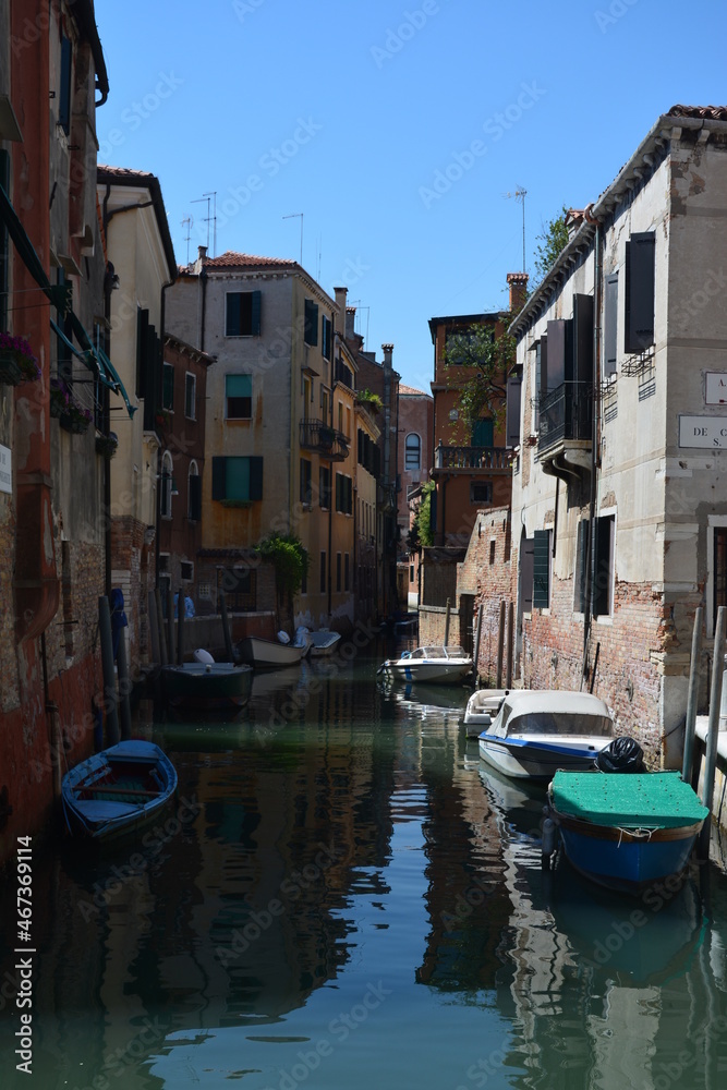 The tranquil canals of Venice in the heat of the mid-day sun and summer