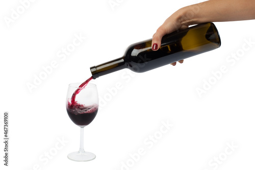 girl pours red wine from bottle into glass isolated on white background