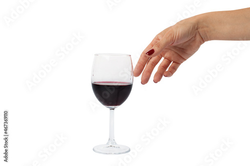 a female hand touches a glass with red wine a large plan is isolated on a white background. Alcohol, alcoholism, taste, haze, aperitif