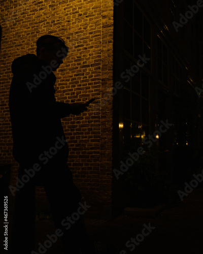 silhouette of a person in the city on phone