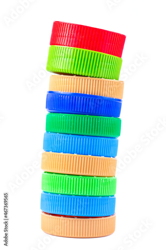 Pile of colored plastic caps isolated on white background. Recycling concept. Recycling collection and processing plastic bottle caps.
