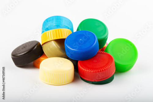 Pile of colored plastic caps on white background. Recycling concept.