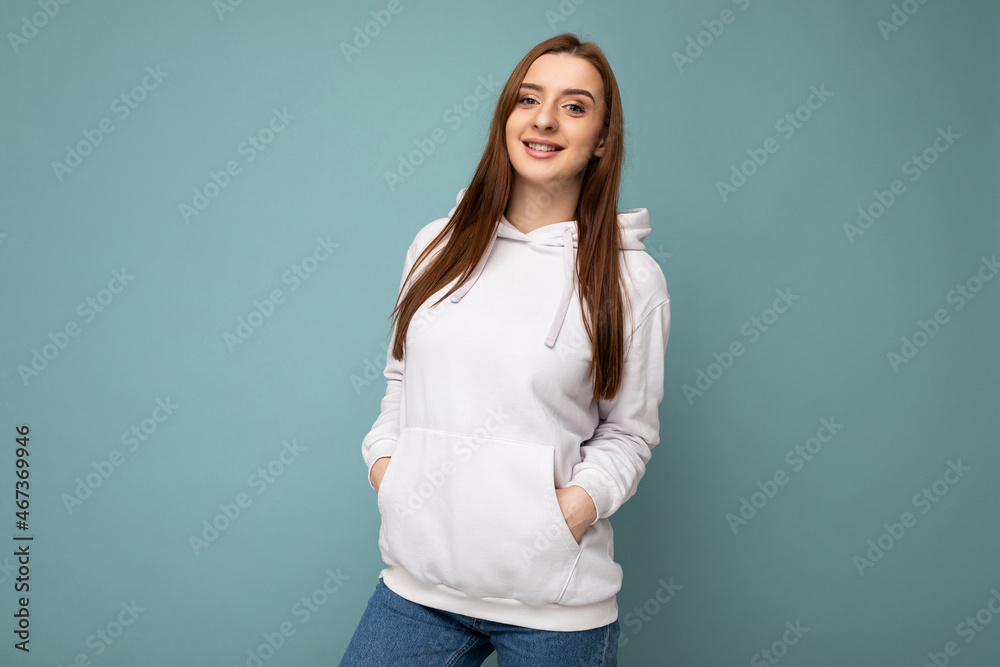 Photo of beautiful positive smiling adult woman wearing stylish clothes standing isolated on colorful background with copy space looking at camera Photo of beautiful positive smiling adult woman wearing stylish clothes standing isolated on colorful background with copy space looking at camera