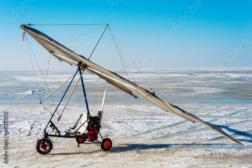 White sport hang glider on an ice field 