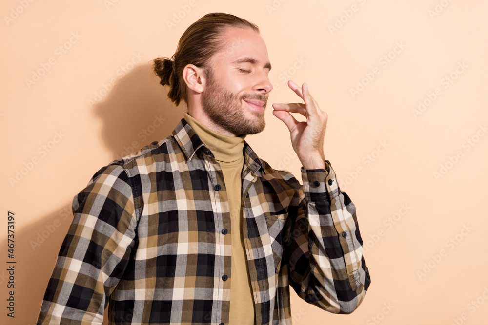 Profile side photo of young dreamy guy show fingers tasty symbol isolated over beige color background