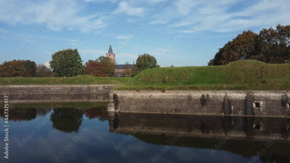 Fortress City Naarden Vesting in The Netherlands With Church and beautiful water reflections on a windless day, Aerial left to right Fortress City Naarden Vesting in The Netherlands With Church and beautiful water reflections on a windless day, Aerial left to right