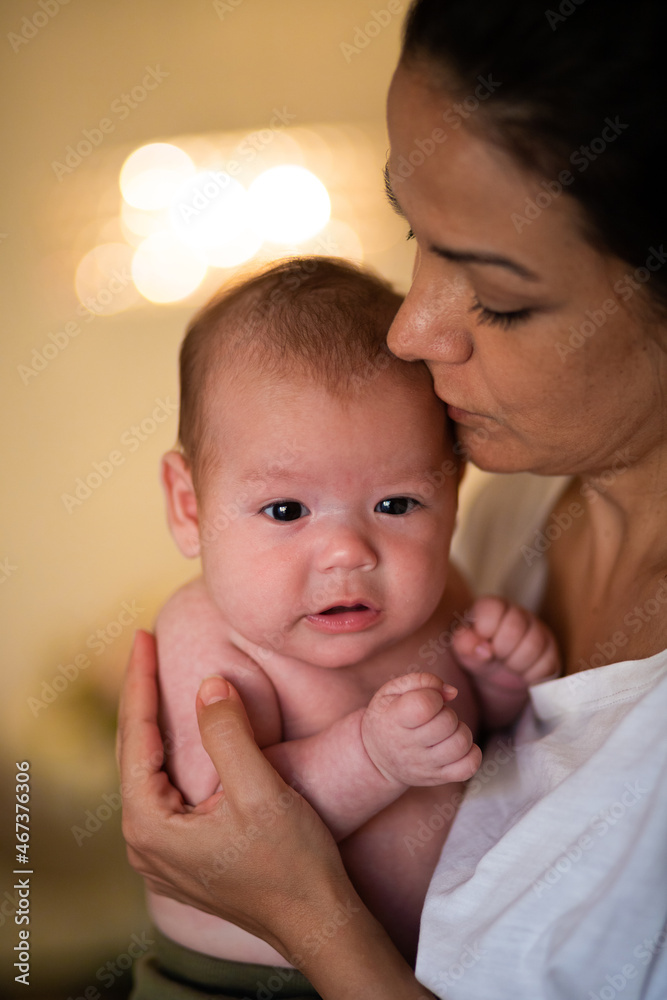 Loving mother hugging newborn at home Loving mother hugging newborn at home