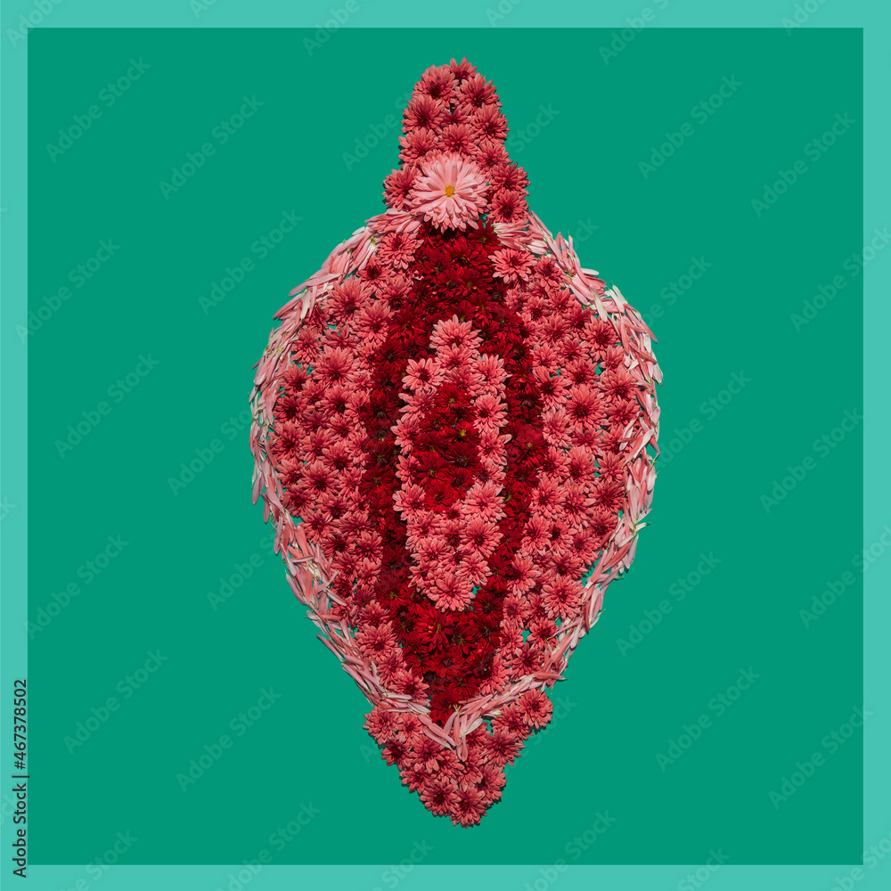 Flower installation of vagina on green background, concept of