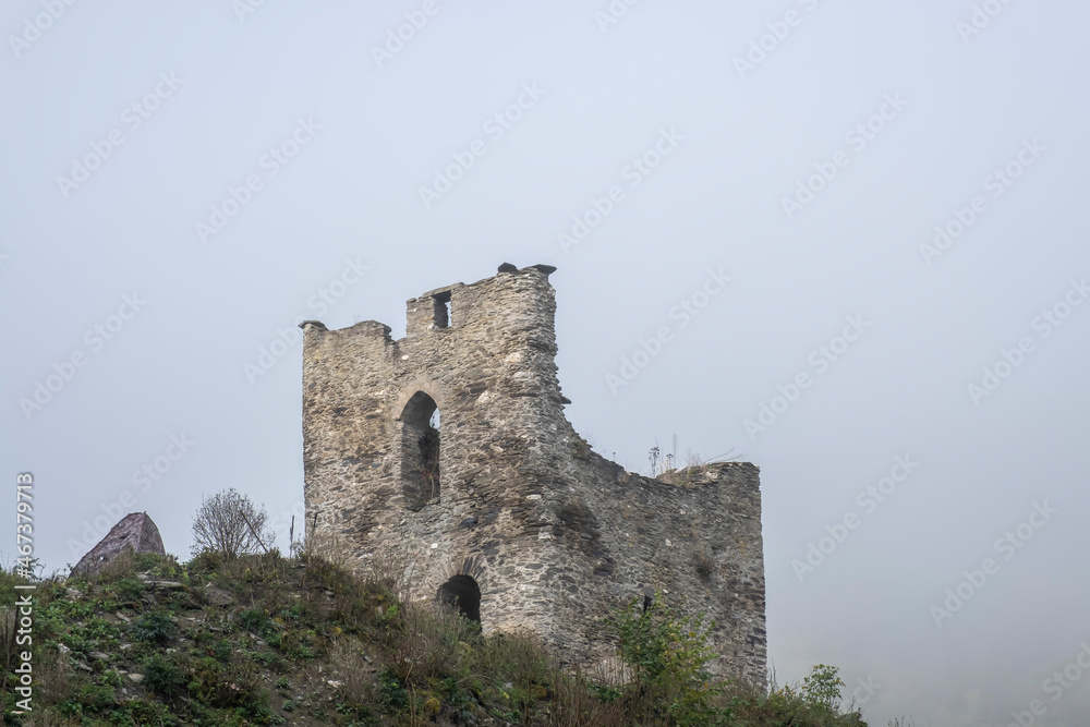 View of the ruins of Lauksburg Castle in the Wispertal / Germany in the fog 