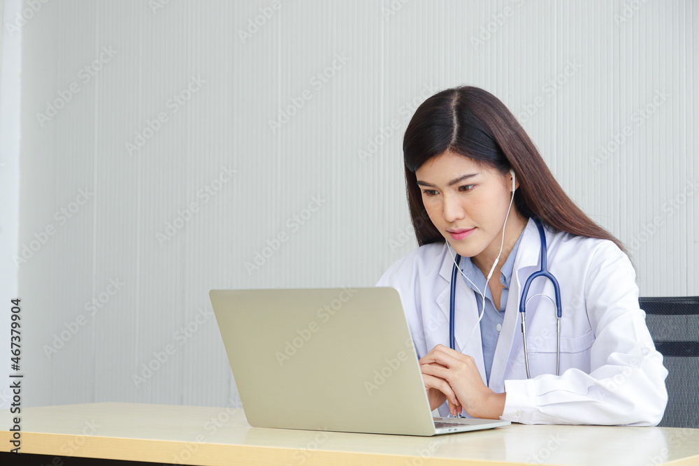 Asian female doctor online video call Check the symptoms with the patient via the Internet. on a laptop computer. The concept is connected to communication through online technology. Asian female doctor online video call Check the symptoms with the patient via the Internet. on a laptop computer. The concept is connected to communication through online technology.