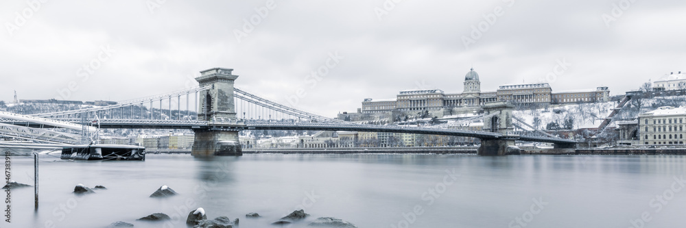 panorama of the Buda castle and the Chain Bridge above the Danube river in Budapest, Hungary, in winter