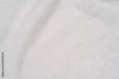 White delicate soft background of plush fabric is beautiful warm winter cloth