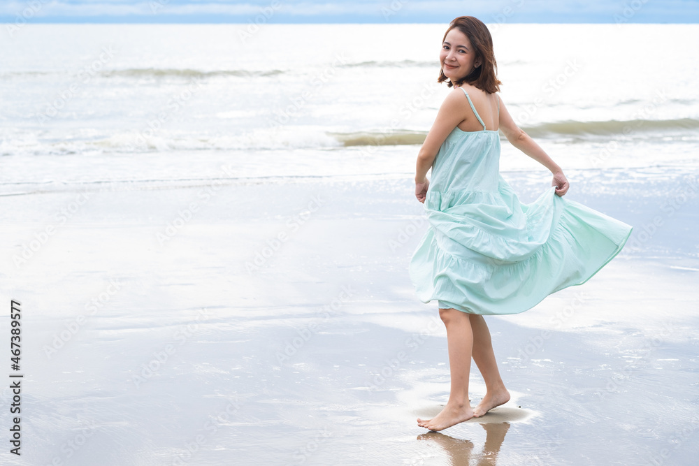 young pretty woman looking and walking on the beach ocean at tropical beach, enjoy her freedom and fresh air, wearing stylish hat and clothes. Outdoor summer portrait. young pretty woman looking and walking on the beach ocean at tropical beach, enjoy her freedom and fresh air, wearing stylish hat and clothes. Outdoor summer portrait.