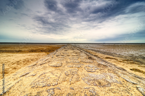 view along a groin to the sea at low tide photo