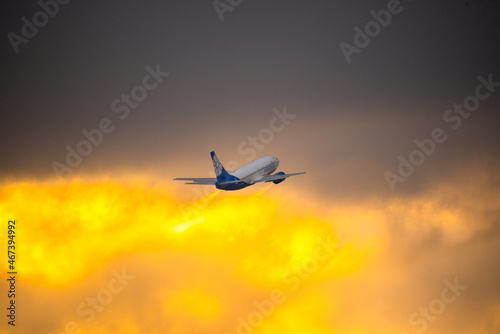 Airplane in the sky at sunrise photo