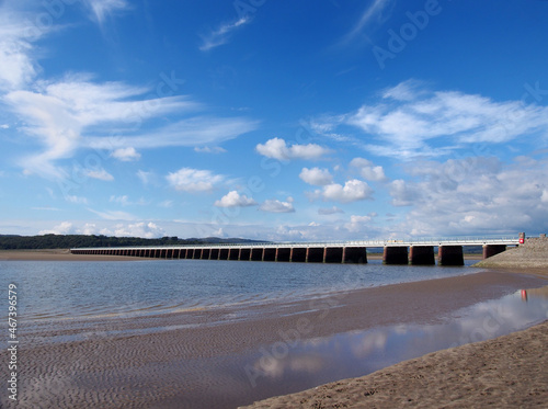 view of the beach at arnside with the leven railway viaduct and river in the south lakes area of cumbria