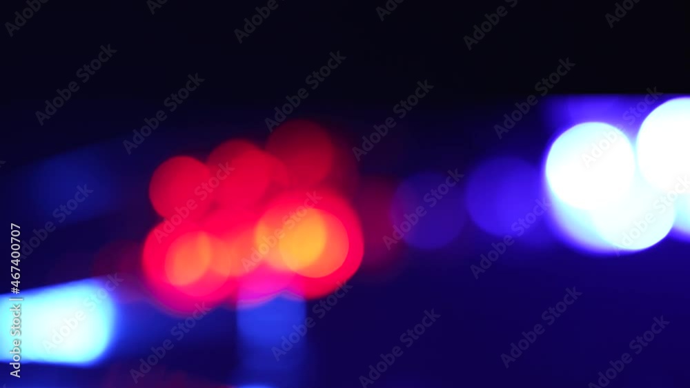 Lens flares from a police car flashers. Red and blue light flash