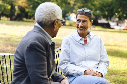 Adult mixed race woman sitting in conversation with her elderly mother