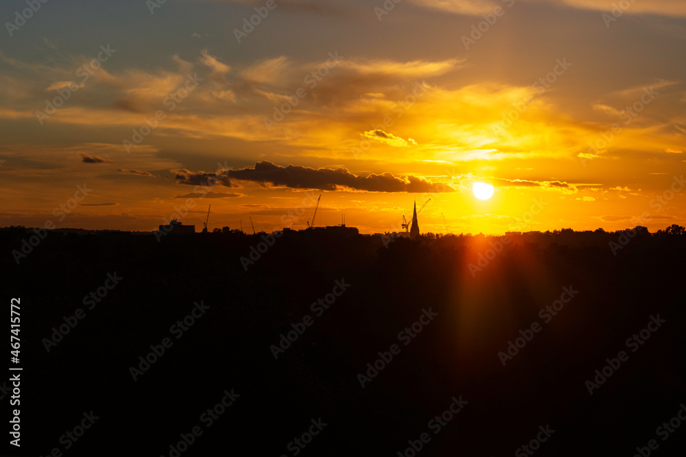 The orange glow from London city landscape sunset