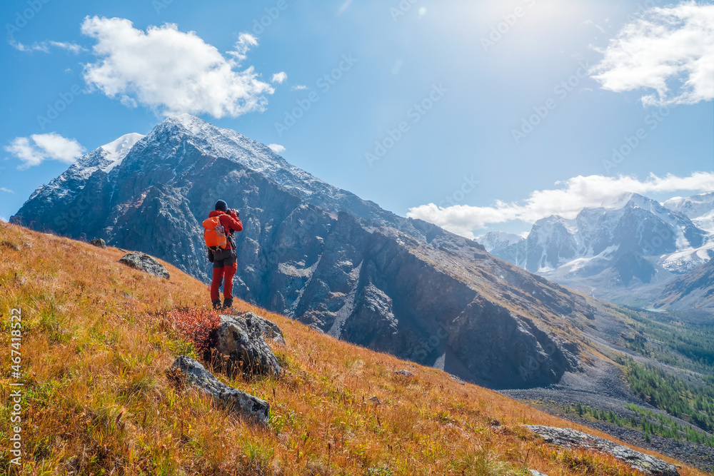 Travel photographer take a picture of beautiful view in high snow mountains. Travel freelancer blogger lifestyle, concept adventure voyage outdoor.