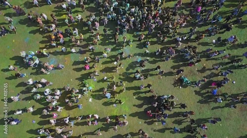 A large number of people at the festival of colors in summer. Drone shooting.